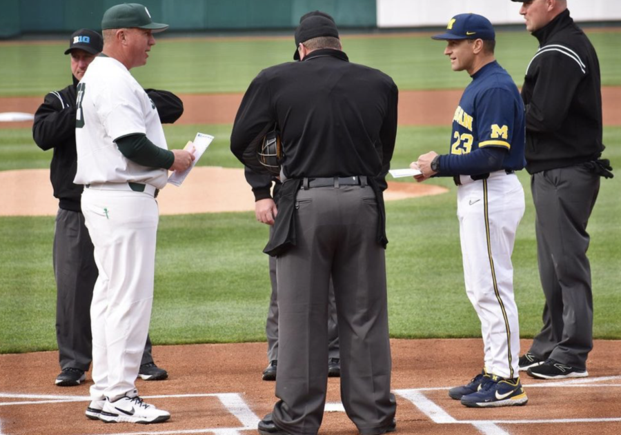 MSU coach Jake Boss hands his lineup card to an umpire before the Spartans take on Michigan on April 15, 2022/ Photo Credit: MSU Athletic Communications 