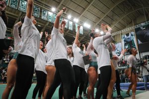 The Michigan State Gymnastics team celebrates after their 197.200-196.975 victory over No. 3 Michigan on January 22, 2023. Photo Credit: Sarah Smith/WDBM