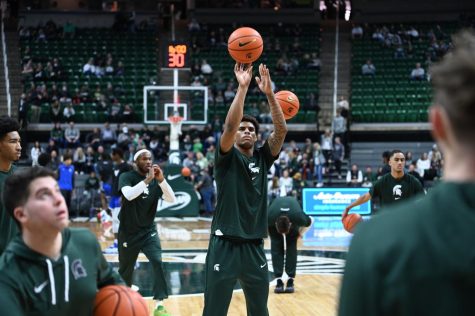 Keon Coleman warms up with Michigan States basketball team ahead of the Spartans game against Buffalo on December 30, 2022. Photo Credit: Jack Moreland/WDBM