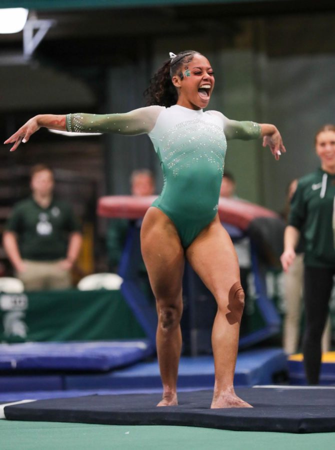 Nyah Smith celebrates after she stuck the landing on her floor routine during Michigan States 197.450-195.475 victory over Penn State on February 4, 2023. Photo Credit: Sarah Smith/WDBM