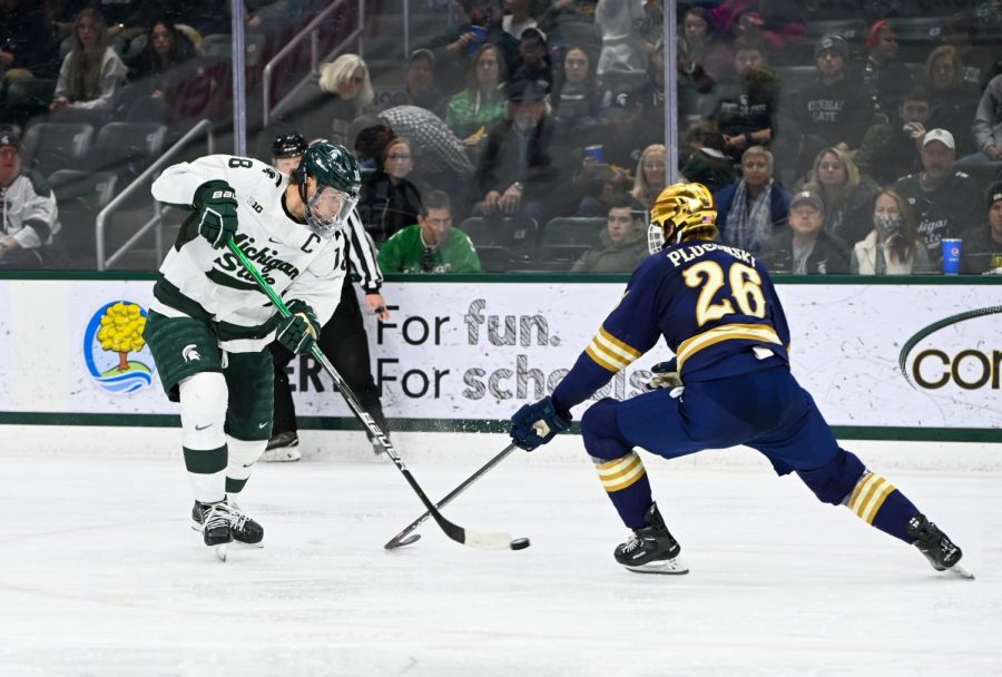 Miroslav Mucha passes the puck passed a defender during Michigan States 3-2 victory over Notre Dame on February 4, 2023. Photo Credit: Jack Moreland/WDBM