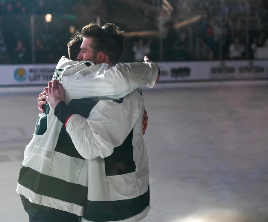 The Krygier brothers embrace each other on senior night at Munn Ice Arena on February 4, 2023. Photo Credit: Jack Moreland/WDBM