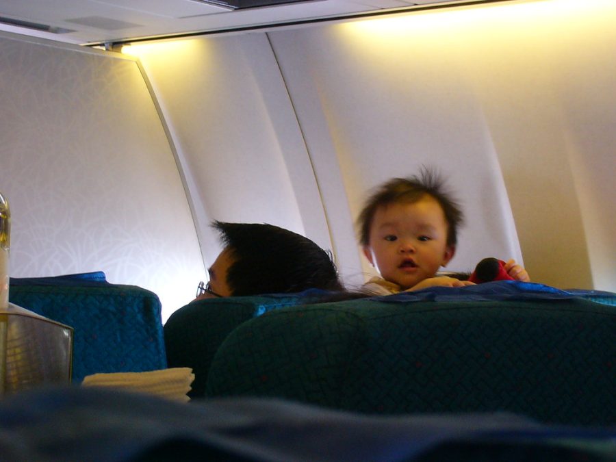 A baby on board the plane back home by kerfern is licensed under CC BY-NC-SA 2.0.