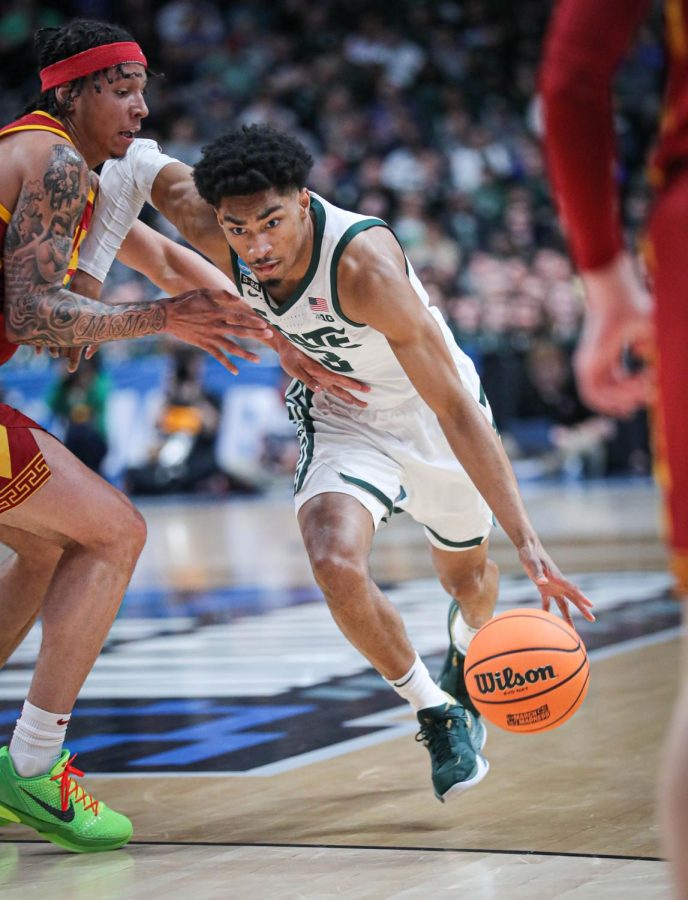 Jaden Akins dribbles passed a defender during Michigan States 72-62 victory over USC in the first round of the NCAA Tournament on March 17, 2023. Photo Credit: Sarah Smith/WDBM