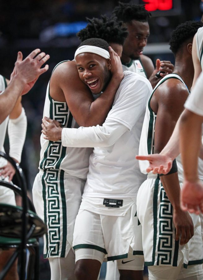 Trey Holloman and AJ Hoggard celebrate during a timeout during Michigan States 72-62 victory over USC in the first round of the NCAA Tournament on March 17, 2023. Photo Credit: Sarah Smith/WDBM