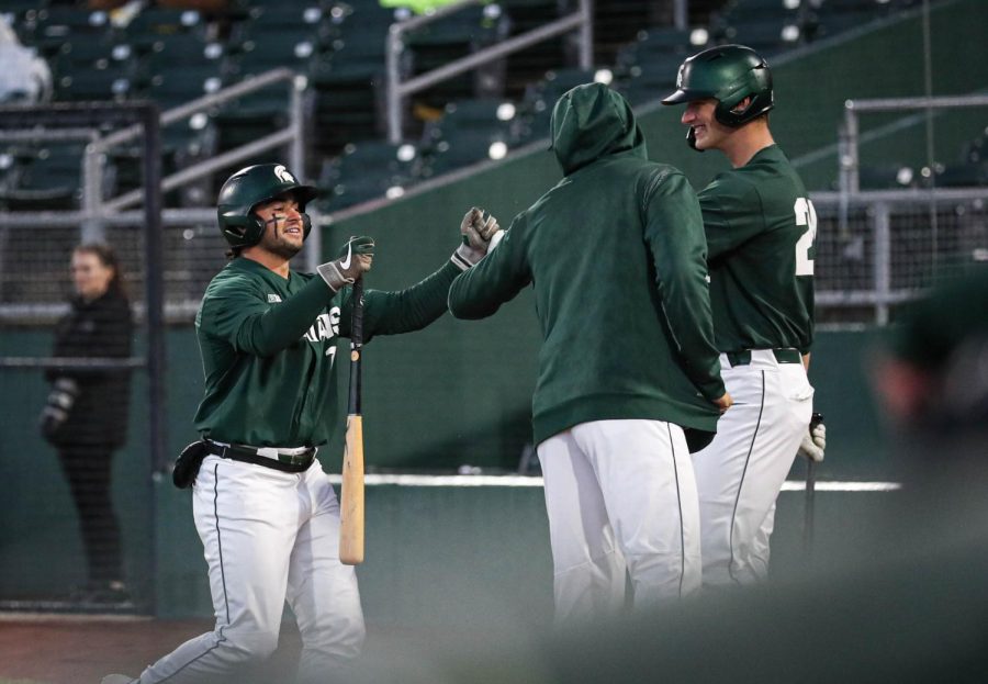 Trent Farquhar returns to Michigan State’s dugout after scoring a run during the Crosstown Showdown on April 4, 2023. Photo Credit: Sarah Smith/WDBM