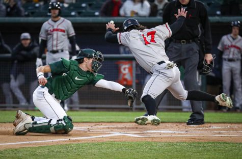 A Lugnuts runner evades a tag from Michigan State’s Bryan Broecker during the Crosstown Showdown on April 4, 2023. Photo Credit: Sarah Smith/WDBM
