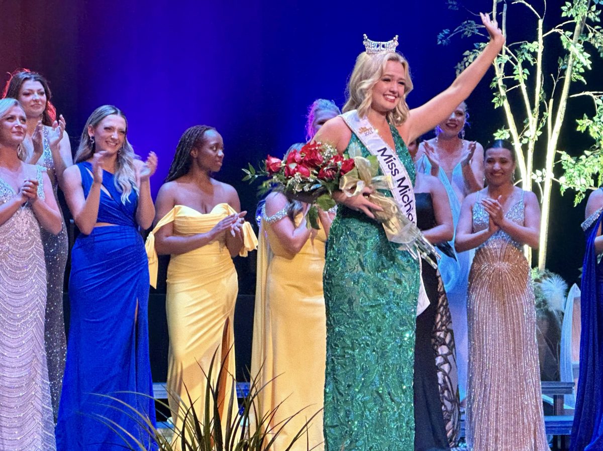Maya Schuhknecht waving to the audience at the Frauenthal Center in Muskegon after being crowned Miss Michigan on June 17. She graduated with her Bachelor of Arts in graphic design from MSU this spring. Photo Credit: courtesy of Maya Schuhknecht