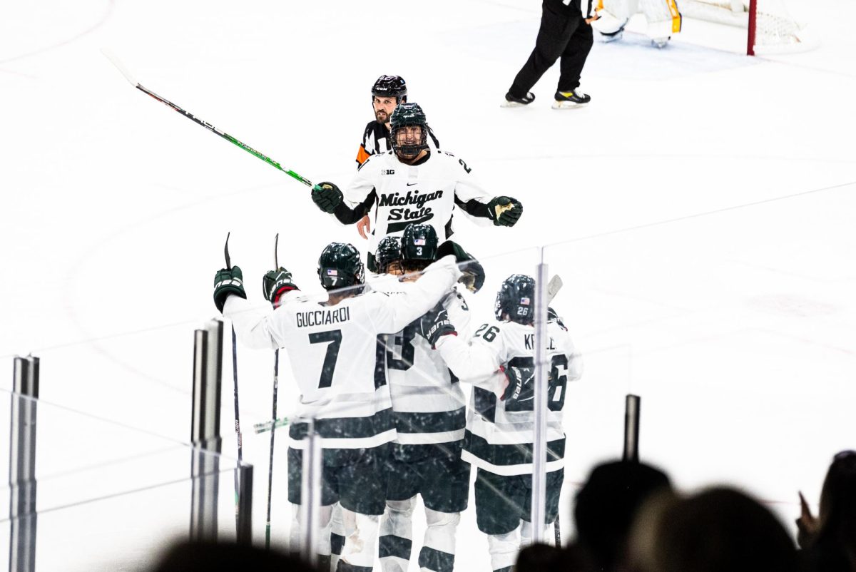 MSU junior forward Red Savage celebrates a goal with teammates in the third period against Lake Superior State on Saturday, October 7, 2023 at Munn Ice Arena.