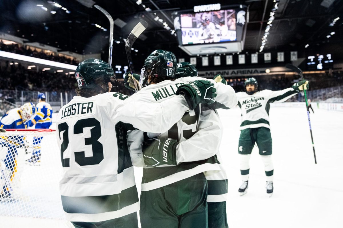 MSU fifth-year forward Nicolas Müller (19) celebrates a goal against Lake Superior State with his teammates on Saturday, October 7, 2023 at Munn Ice Arena.