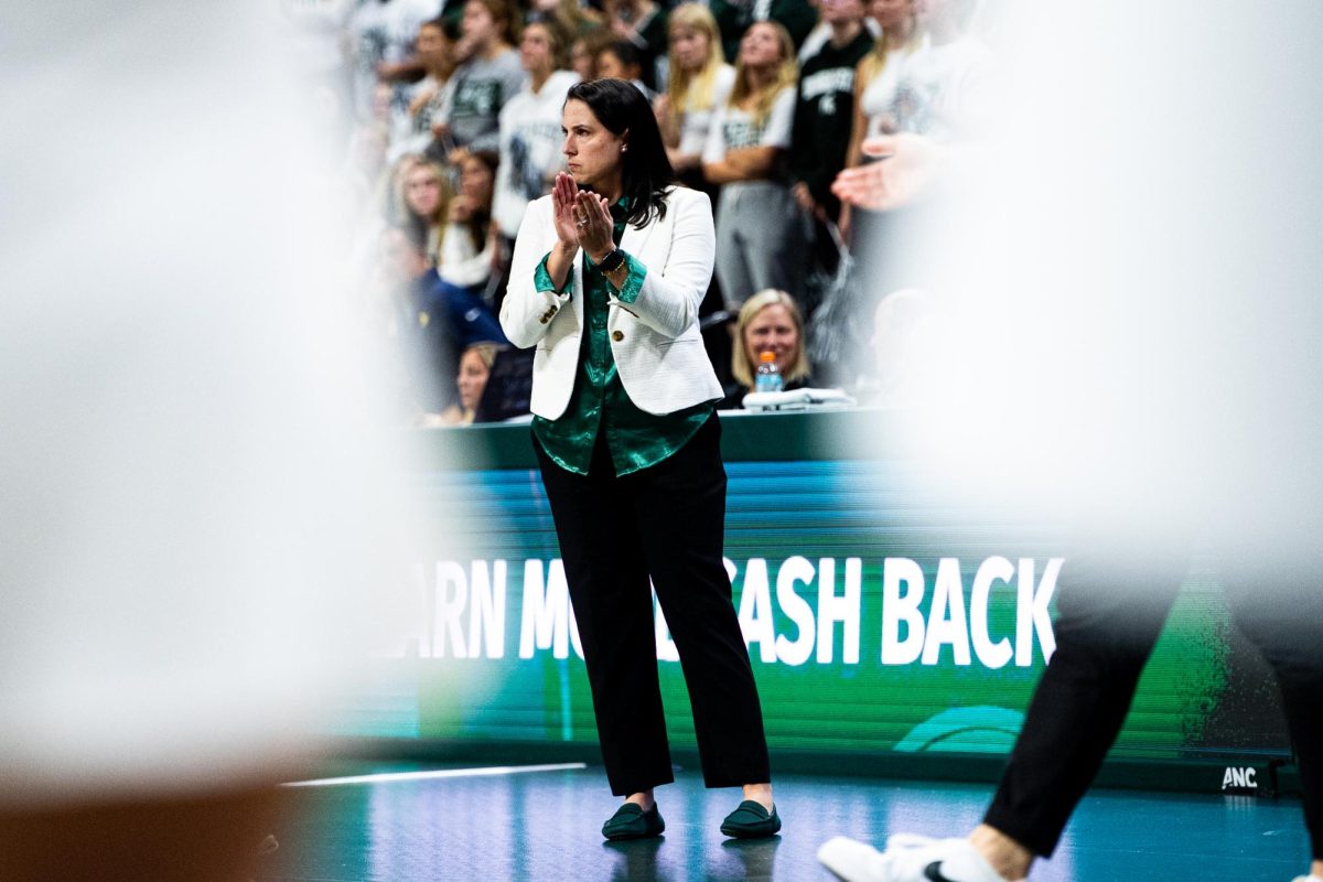 MSU+head+volleyball+coach+Leah+Johnson+watches+her+team+against+Michigan+on+Wednesday%2C+October+18%2C+2023+at+the+Breslin+Center.