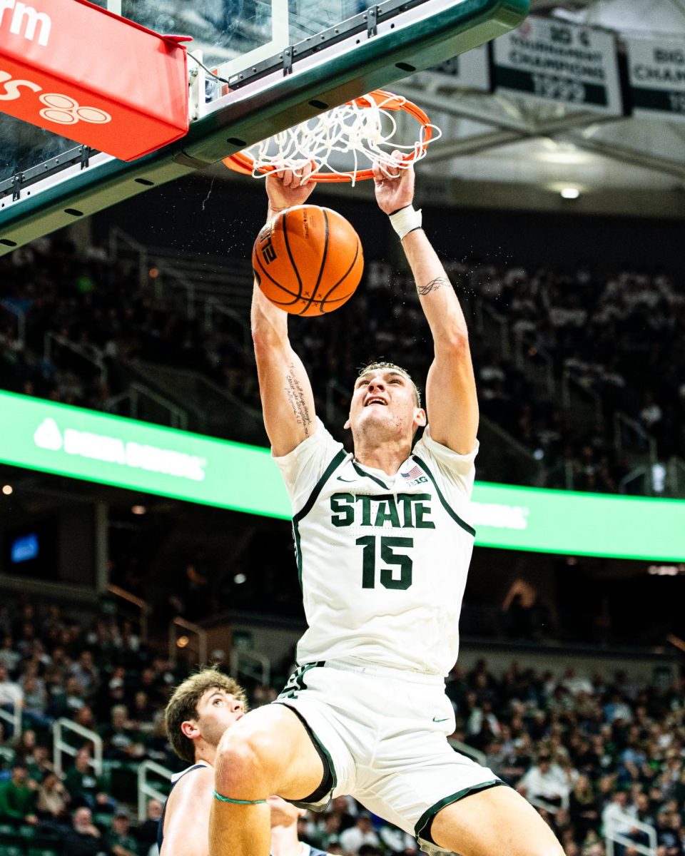 MSU sophomore center Carson Cooper throws down a dunk against Hillsdale on Wednesday, Oct. 25, 2023 at the Breslin Center.