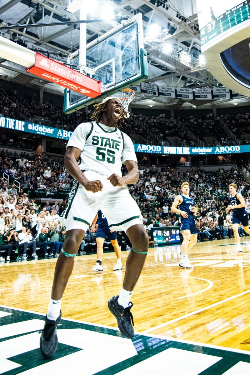 MSU freshman forward Coen Carr celebrates after throwing down a dunk on a fast break against Hillsdale on Wednesday, Oct. 25, 2023 at the Breslin Center.