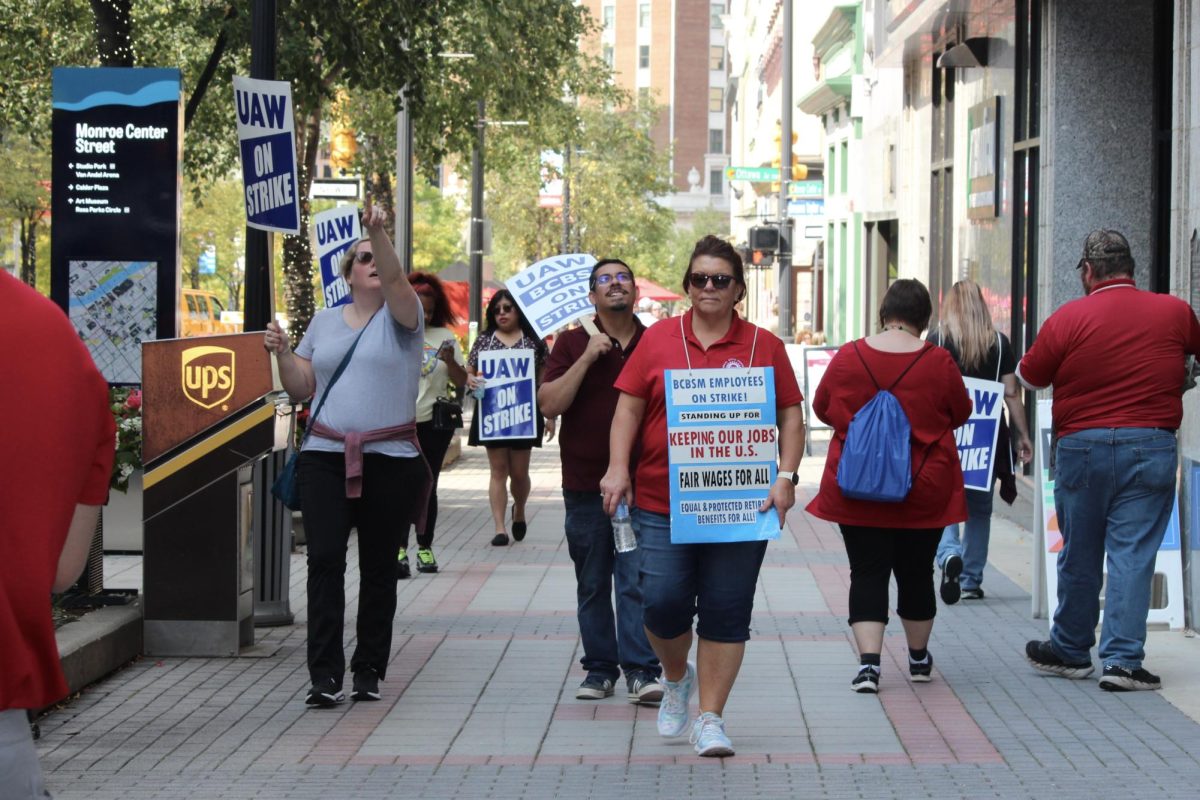 UAW protesters walk the streets of Grand Rapids on Sept. 20. The demonstration is part of a coordinated effort to negotiate a contract deal with the Big Three auto manufacturers. Photo Credit: Sophia Deiters/WDBM