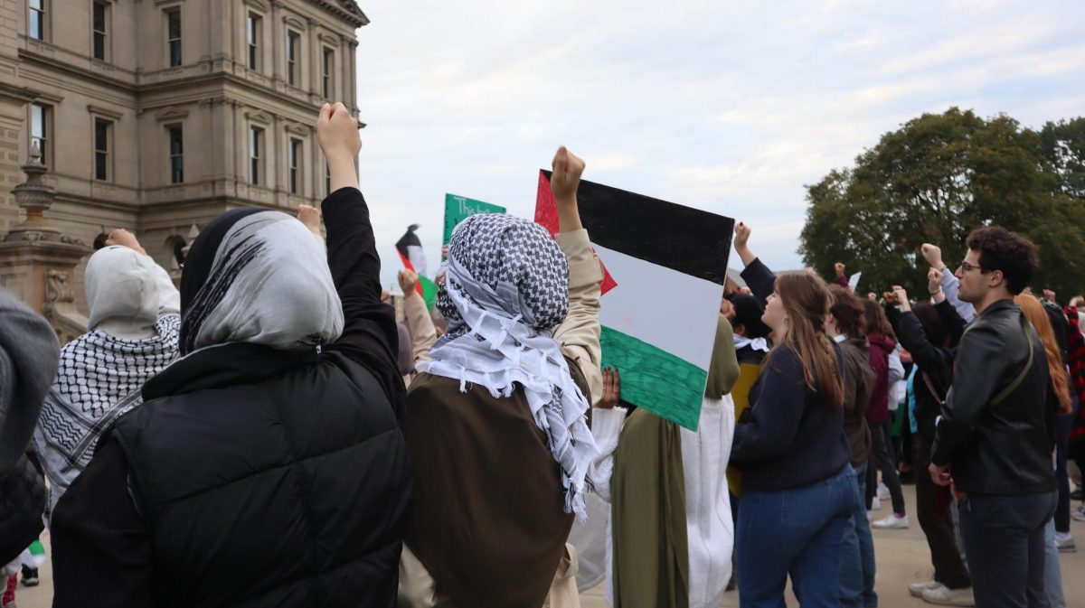 Students and community members chant Free, free Palestine, with fists raised. Photo Credit: Sophia Deiters/WDBM