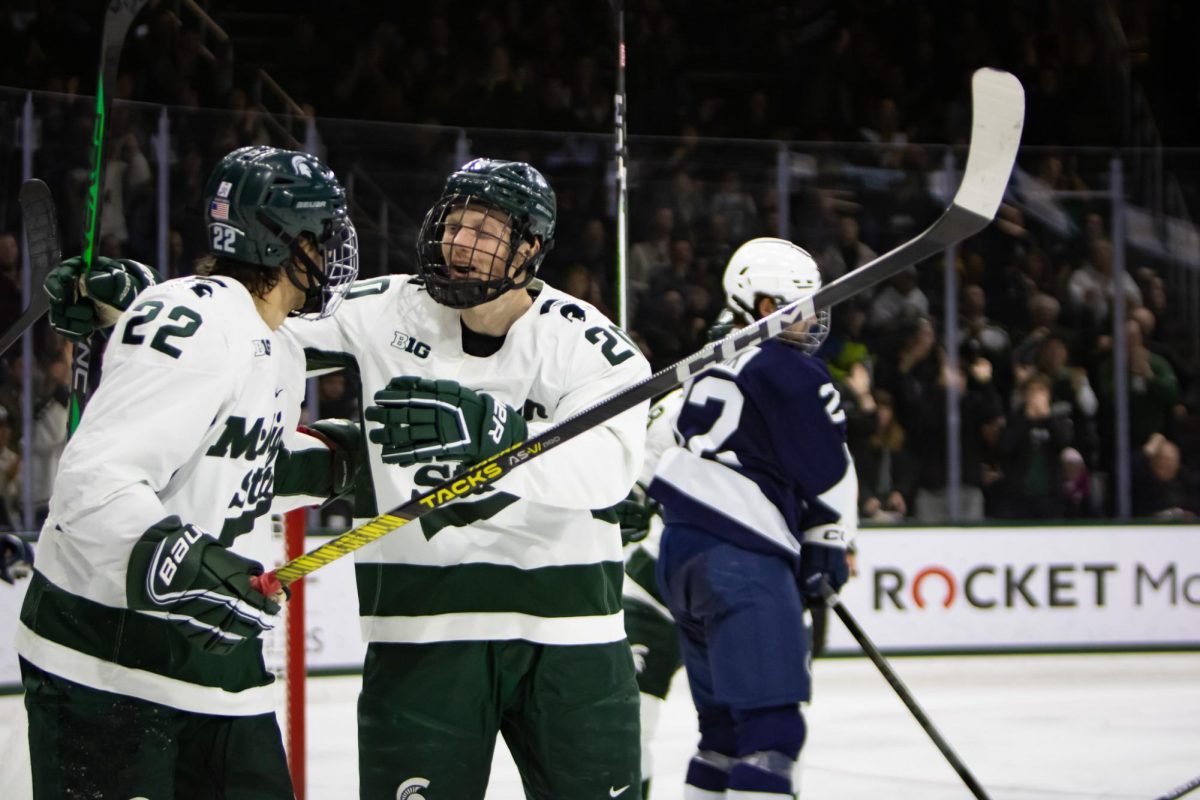 MSU+sophomore+forward+Daniel+Russell+%2820%29+celebrates+after+scoring+off+an+assist+by+sophomore+forward+Isaac+Howard+%2822%29+against+Penn+State+on+Friday%2C+November+10%2C+2023+at+Munn+Ice+Arena.