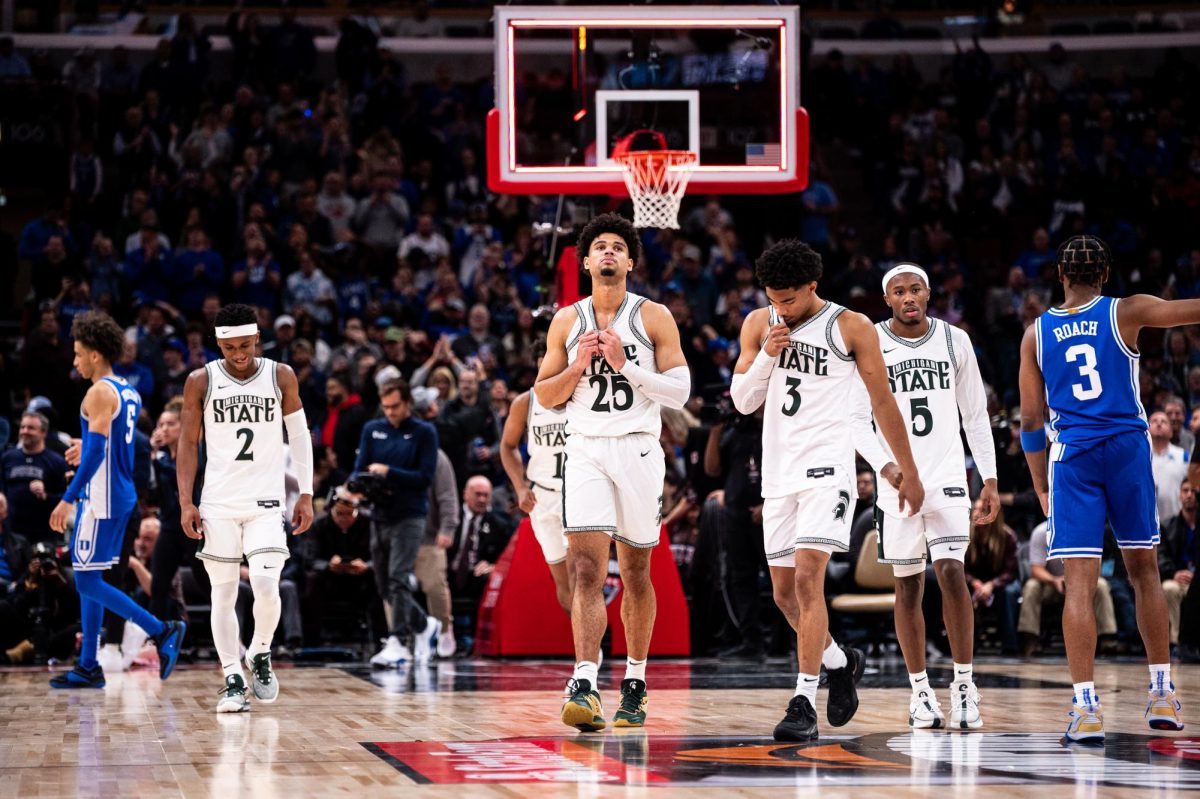 MSU+graduate+guard+Tyson+Walker+%282%29+leaves+the+court+with+teammates+%28from+left%29+graduate+forward+Malik+Hall%2C+junior+guard+Jaden+Akins+and+sophomore+guard+Tre+Holloman+after+falling+to+Duke+on+Tuesday%2C+November+14%2C+2023+at+the+United+Center+in+Chicago.