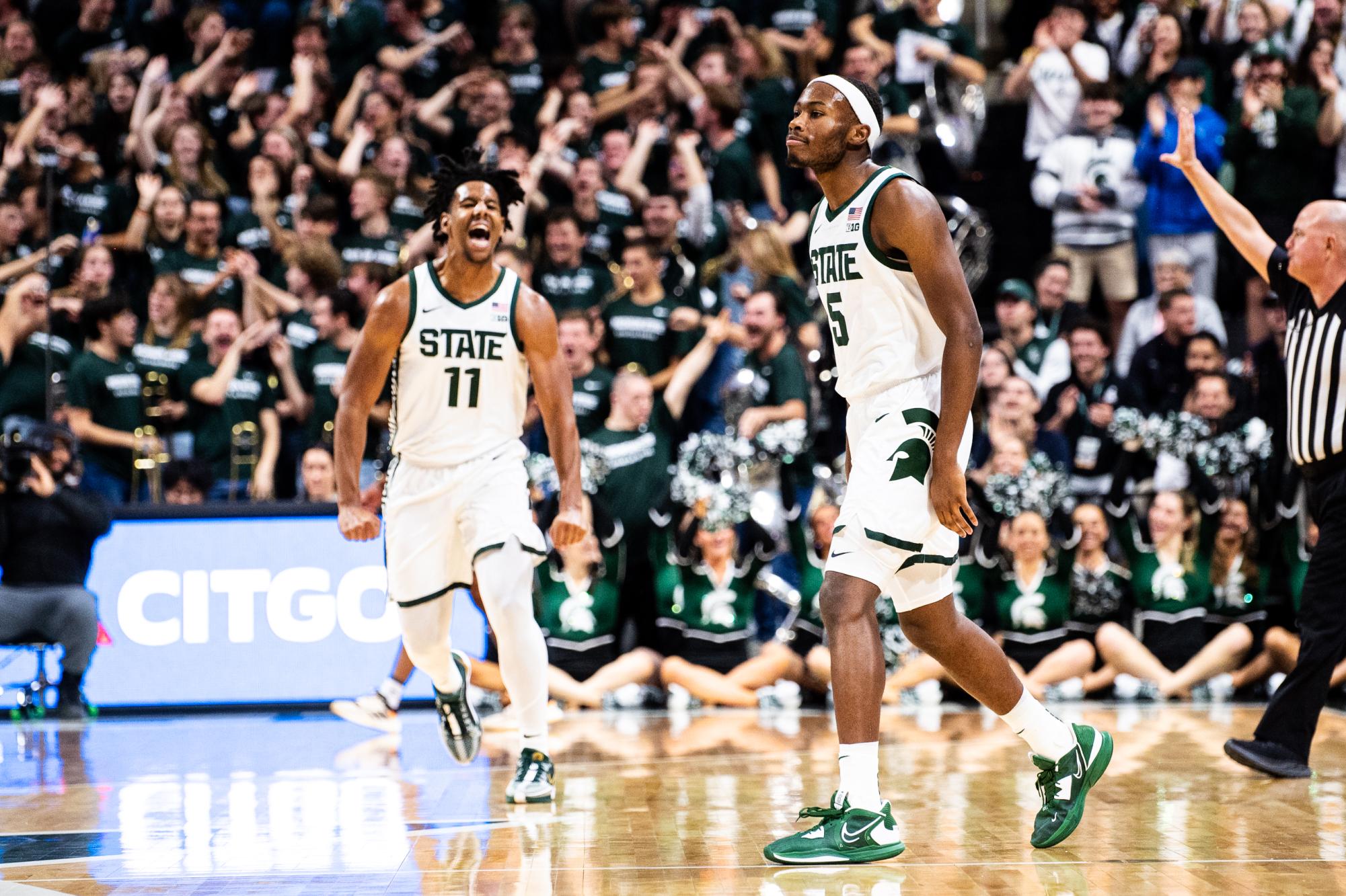 MSU sophomore guard Tre Holloman (right) celebrates with senior guard A.J. Hoggard after hitting a three-pointer against Alcorn State on Sunday, November 19, 2023 at the Breslin Center.
