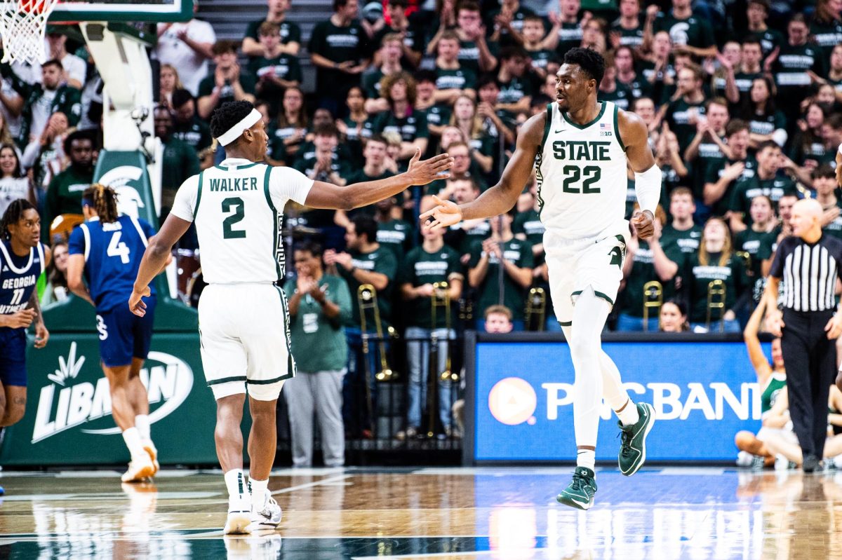 MSU graduate guard Tyson Walker (2) and senior forward Mady Sissoko celebrate after a Sissoko basket against Georgia Southern on Tuesday, November 28, 2023 at the Breslin Center.