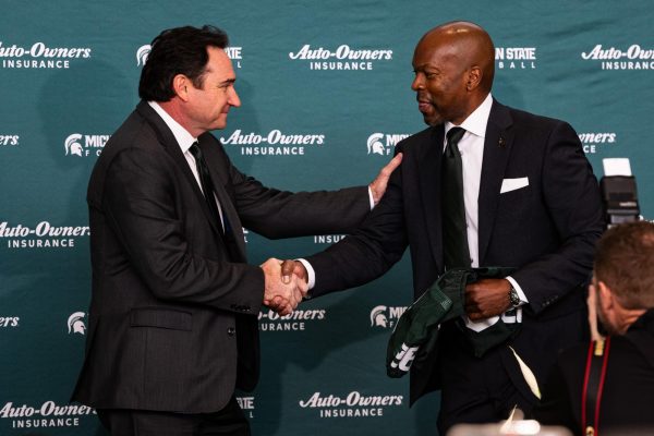 MSUs new head football coach Johnathan Smith (left) shakes hands with MSU Vice President and Athletic Director Alan Haller at his introductory press conference on Tuesday, November 28, 2023 at the Breslin Center.