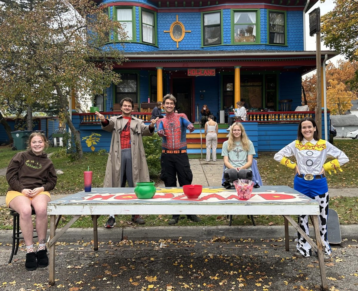 Members of Howland House, a Co-operative house off MSU’s campus, passing out candy to Safe Halloween participants. Photo Credit: Molly Wright/WDBM