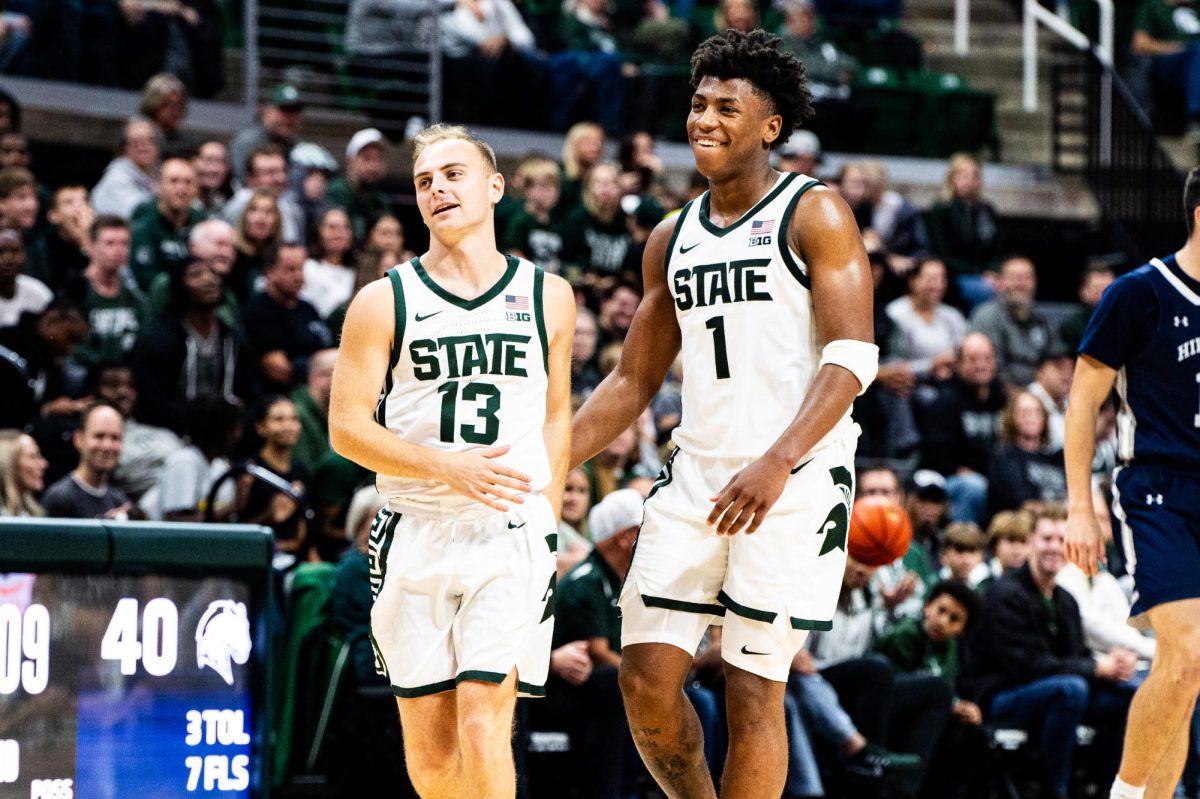 MSU freshman guard Jeremy Fears (1) celebrates as senior guard Steven Izzo checks into the game against Hillsdale on Wednesday, October 25, 2023 at the Breslin Center.