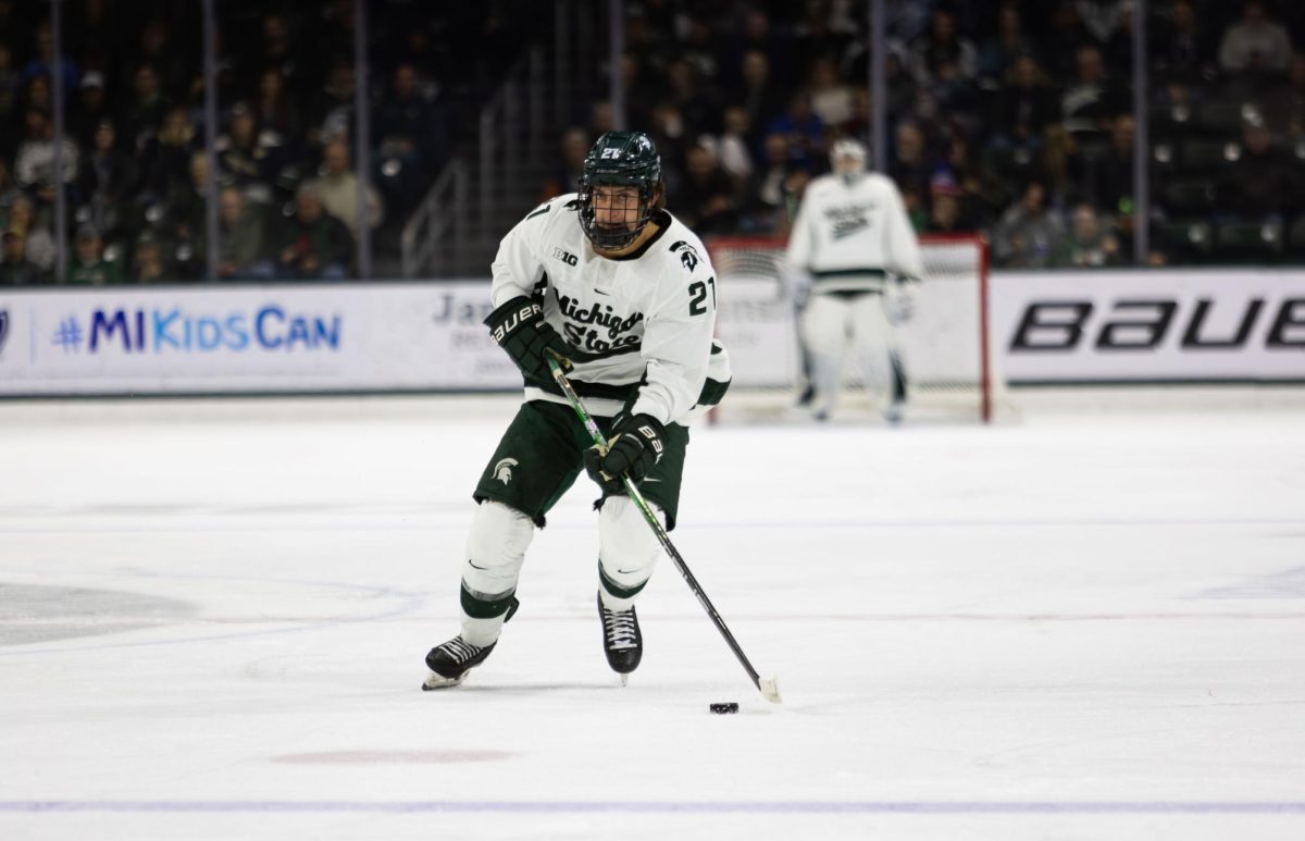 MSU junior forward Red Savage moves the puck against Notre Dame on Saturday, December 9, 2023 at Munn Ice Arena.