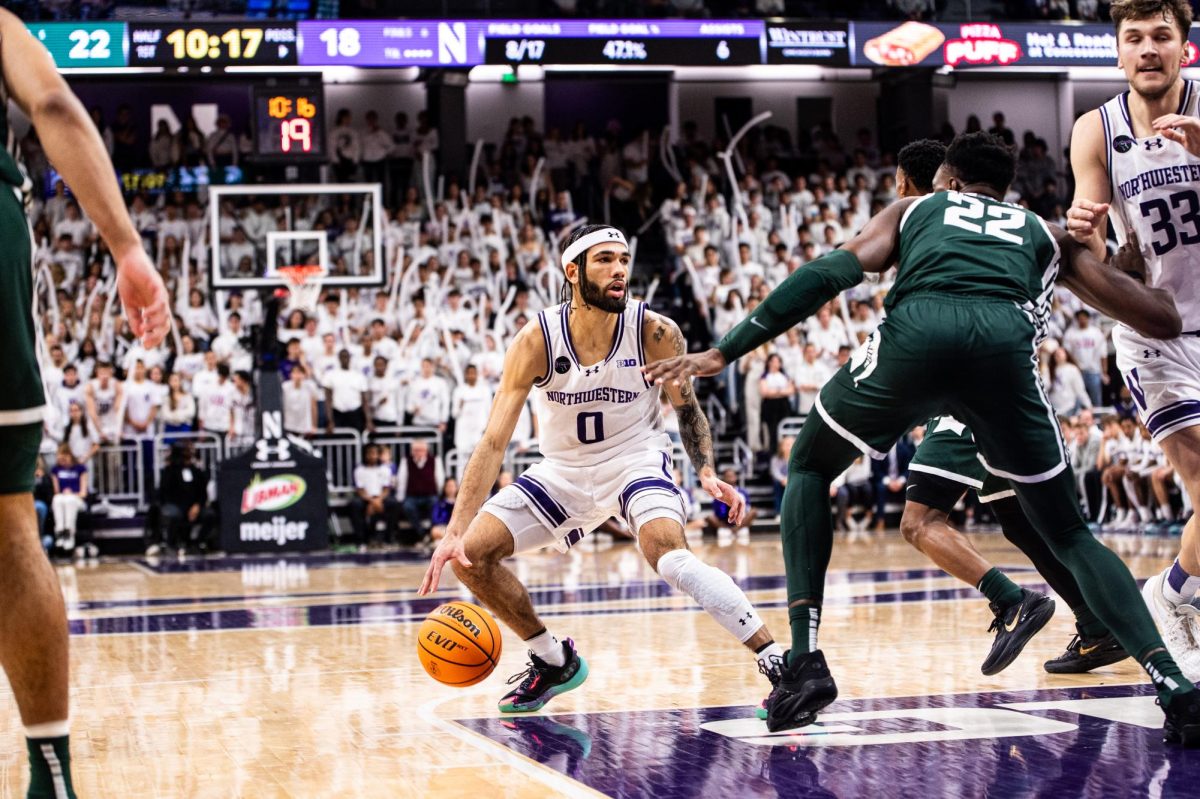 Northwestern graduate guard Boo Buie drives into the lane against MSU on Sunday, January 7, 2024 at the Welsh-Ryan Arena.