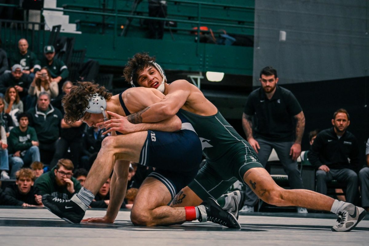 MSU senior Chase Saldate grabs his opponent during the Spartans match against Penn State on Sunday, Jan. 21, 2024 at Jenison Field House.