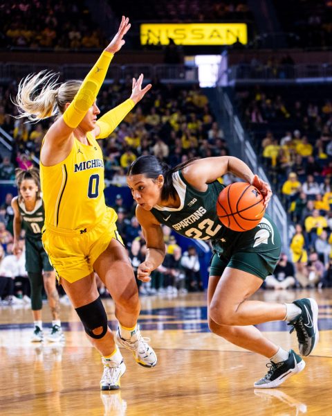 MSU graduate guard Moira Joiner (22) drives to the lane against Michigan on Sunday, Feb. 18, 2024 at the Crisler Center in Ann Arbor.