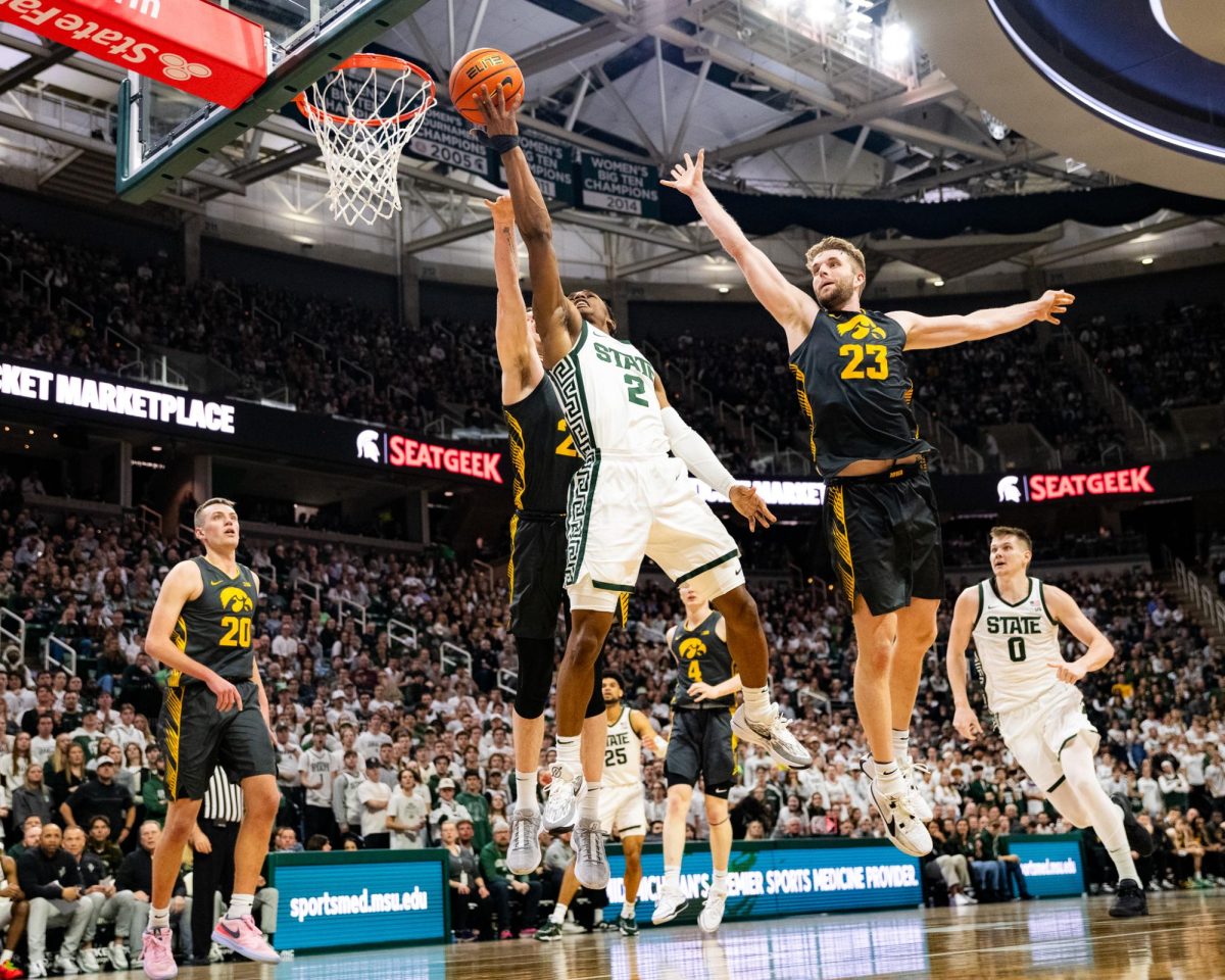 MSU graduate guard Tyson Walker (2) lays the ball up against Iowa on Tuesday, Feb. 20, 2024 at the Breslin Center.