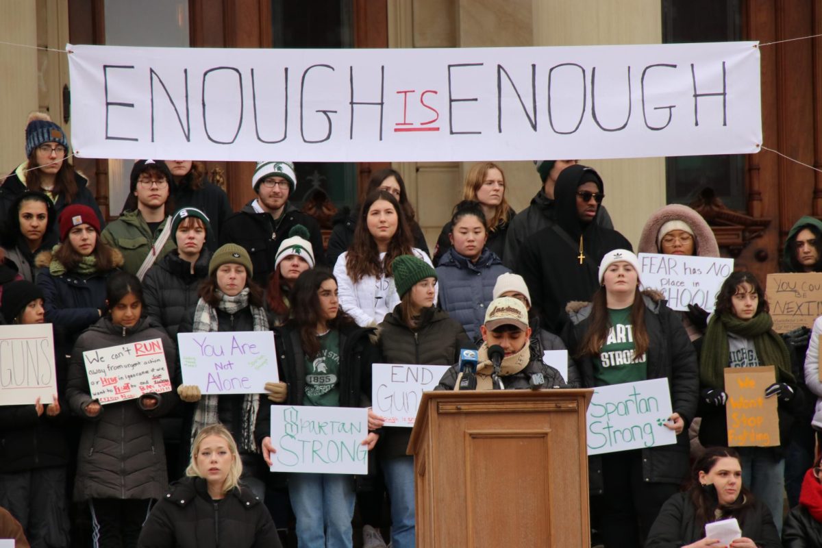 MSU students stand with signs at the Michigan Capitol. Photo Credit: Dakota Hendren/WDBM