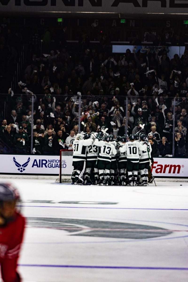 The Spartans celebrate after a 2-1 victory over Ohio State in the B1G Tournament semifinal on Saturday, Mar. 16, 2024 at Munn Ice Arena in East Lansing. (Photo by Avery Kotel)