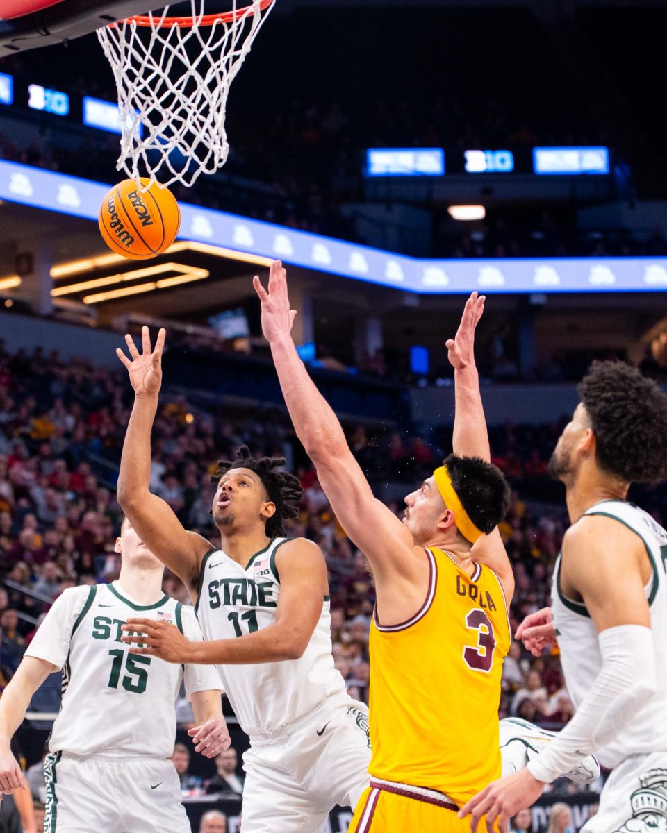 MSU senior guard A.J. Hoggard (11) lays the ball up in the second half of MSUs 77-67 victory over Minnesota in the B1G Mens Basketball Tournament on Thursday, Mar. 14, 2024 at the Target Center in Minneapolis, MN.