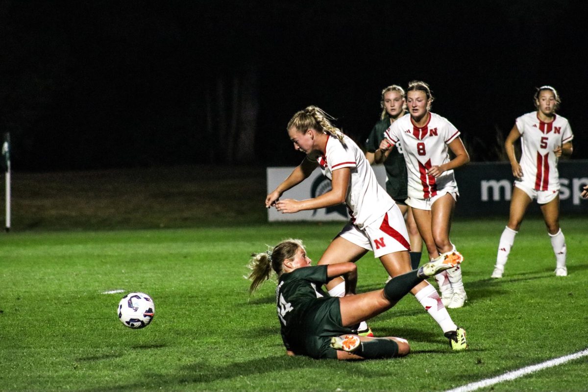 Graduate forward Mackenzie Anthony slides for a block against the Cornhuskers. 