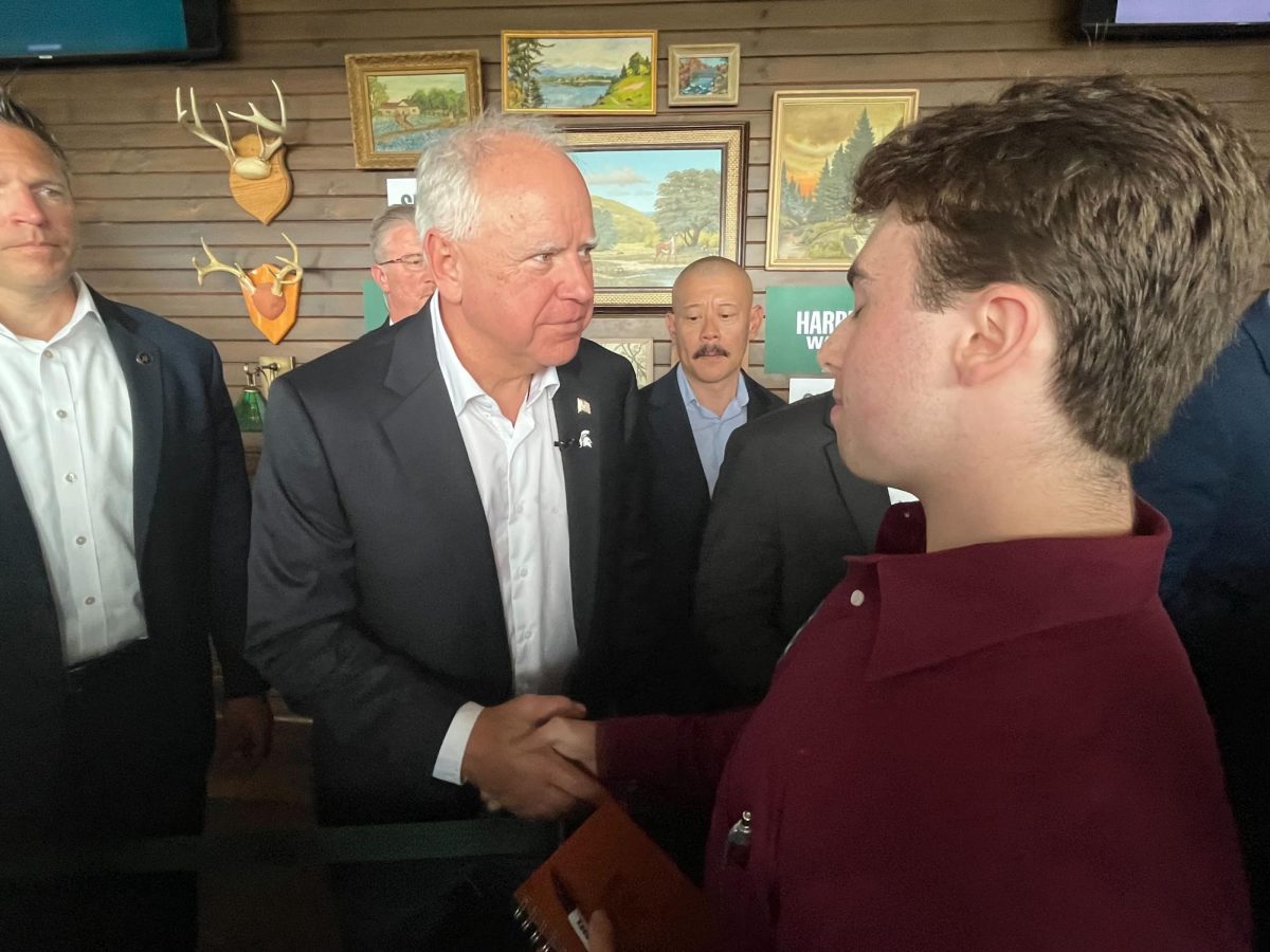 Tim Walz shaking the hand of an attendee at the student engagement event last Friday. Photo Credit: Ryan McClenton