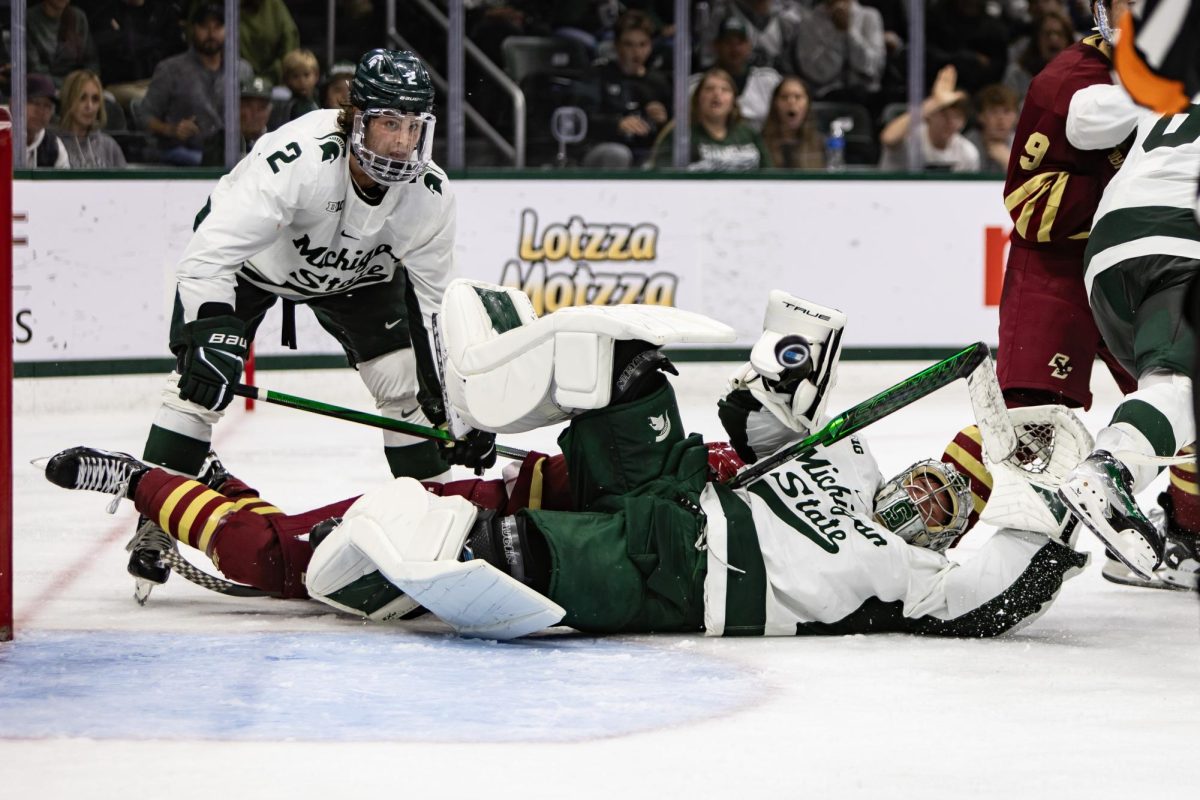 Sophomore goaltender Trey Augustine sprawls to secure the puck in MSU's battle versus Boston College (East Lansing, Oct. 12, 2024). 