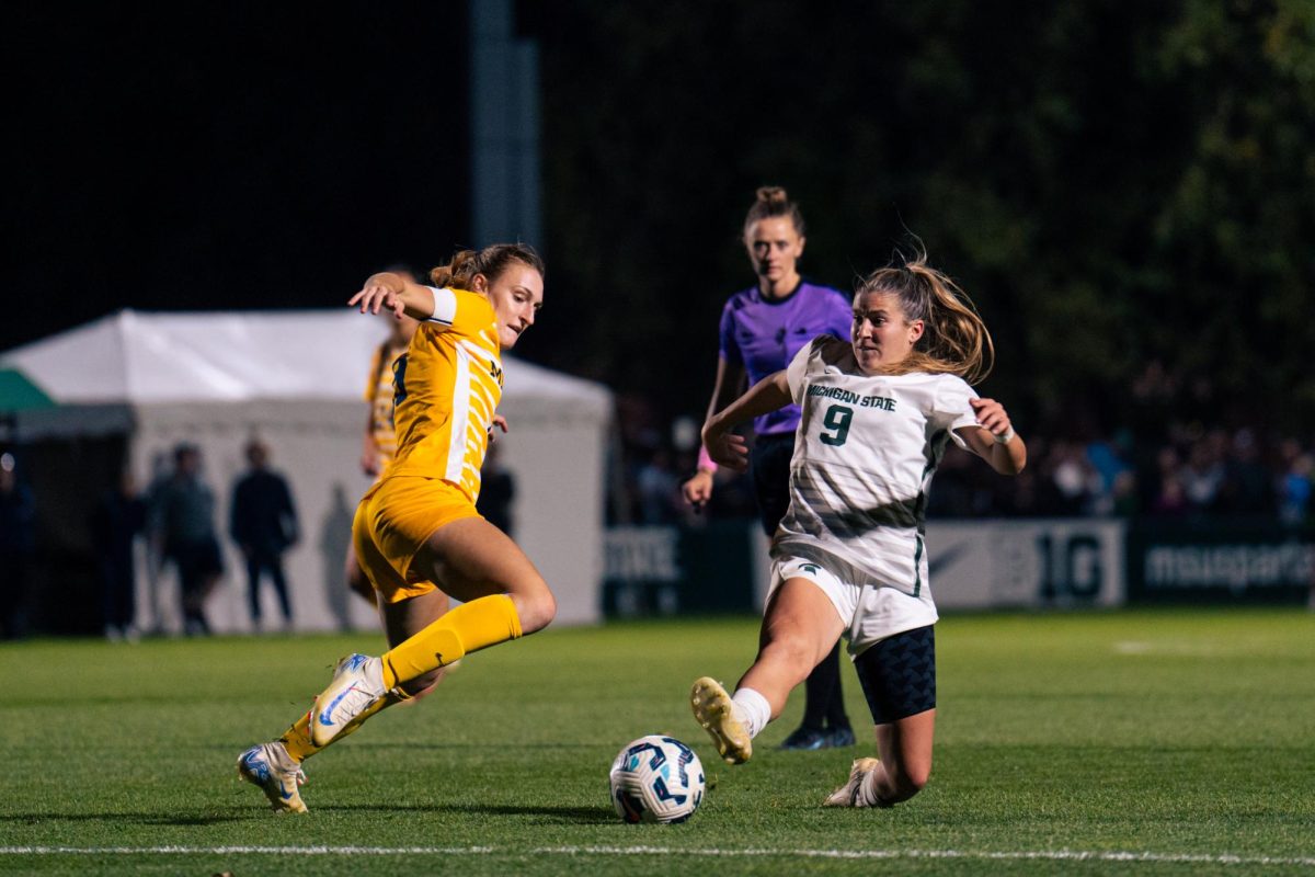 MSU forward Meg Hughes battles against Michigan (East Lansing Oct. 5, 2024). 