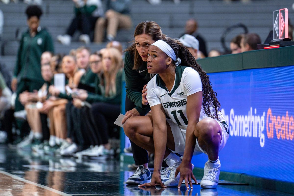 MSU women's basketball head coach Robyn Fralick coaches MSU forward Jocelyn Tate during exhibition against Wayne State (East Lansing, Oct. 28 2024). 