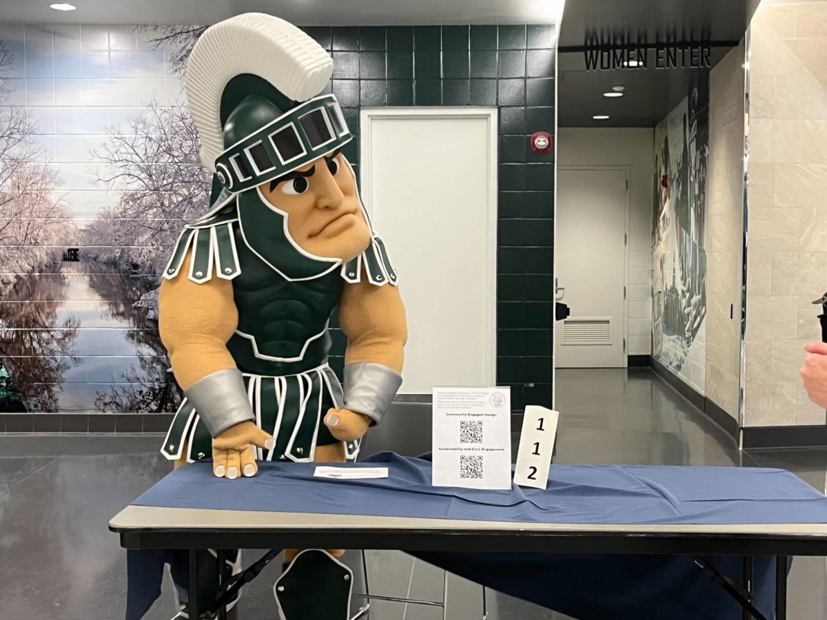 Sparty visits one of the many tables at the Global Learning Expo.
