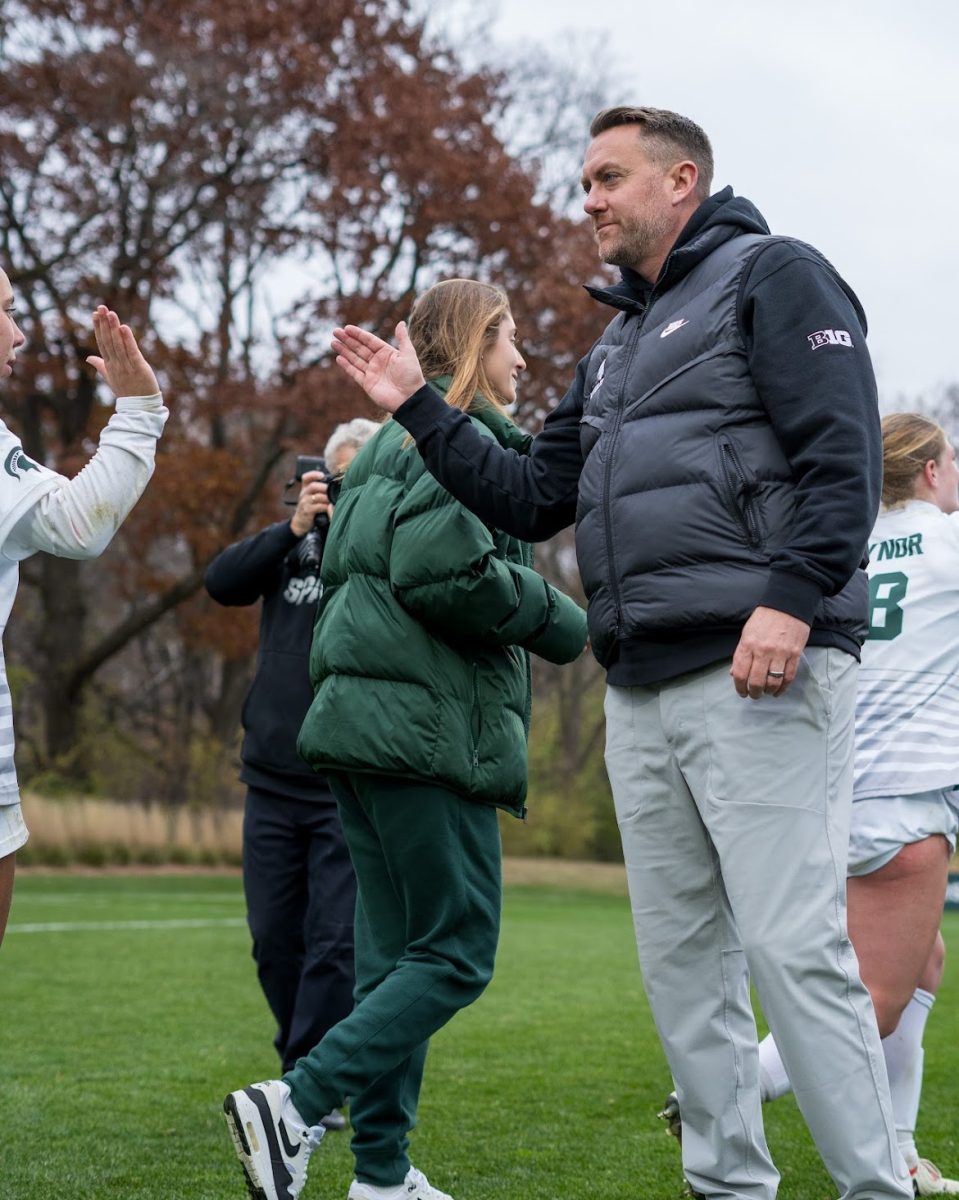 MSU head coach Jeff Hosler celebrates with team after NCAA Tournament round one win (East Lansing, Nov. 15, 2024).