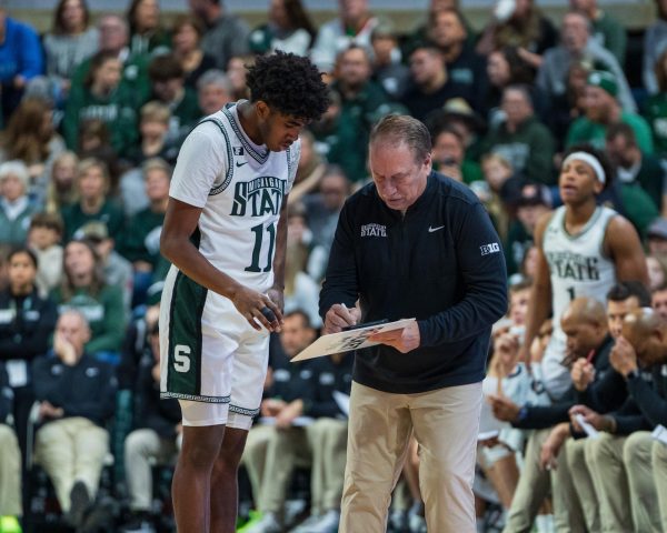 MSU freshman guard Jase Richardson and head coach Tom Izzo look through adjustments versus FAU (East Lansing, Dec. 21 2024).