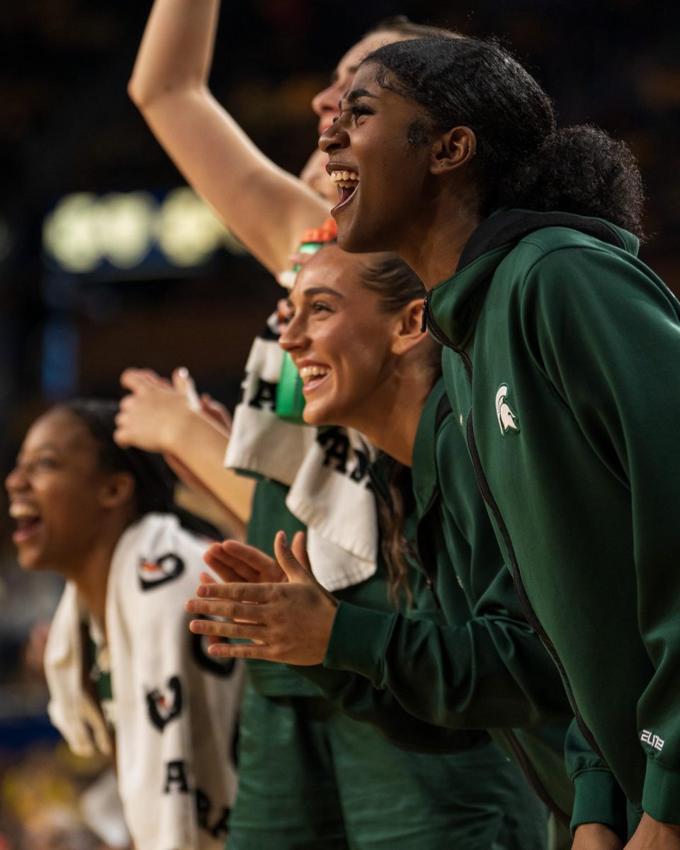 Freshman forward Helen Holley (right) and junior guard Abbey Kimball (left) celebrating on the bench versus Michigan (Ann Arbor, Jan. 25, 2025). 