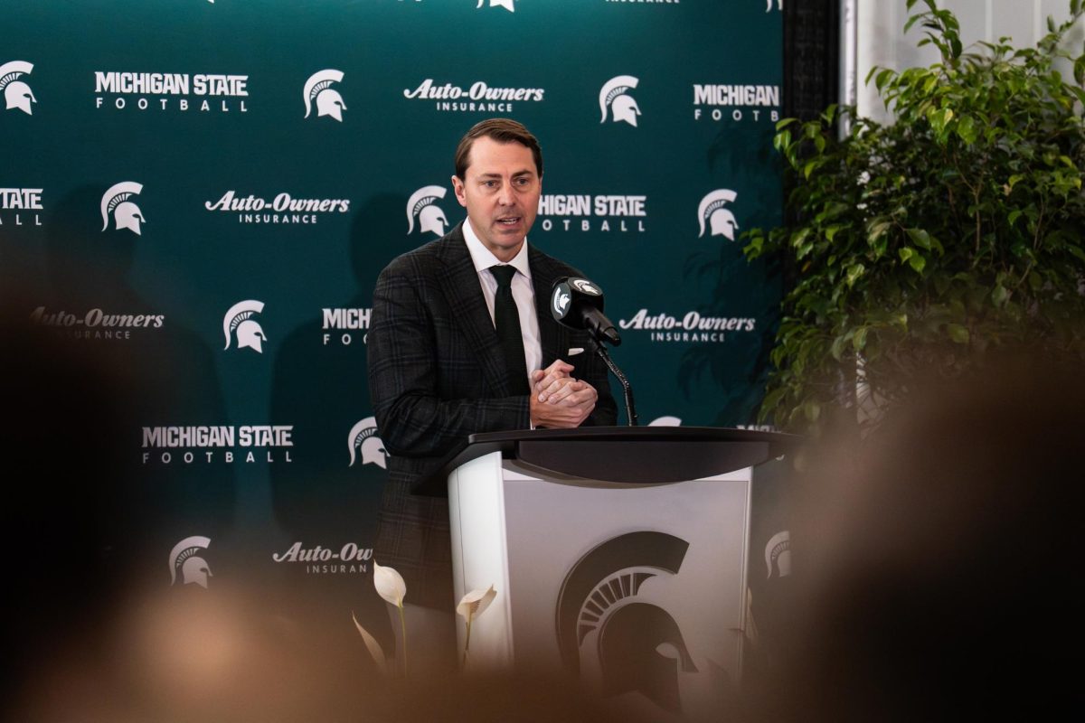 Michigan State director of athletics J Batt at the podium of the Pat Fitzgerald hiring announcement at the Tom Izzo Football Building in East Lansing, Mich. on Dec. 2, 2025