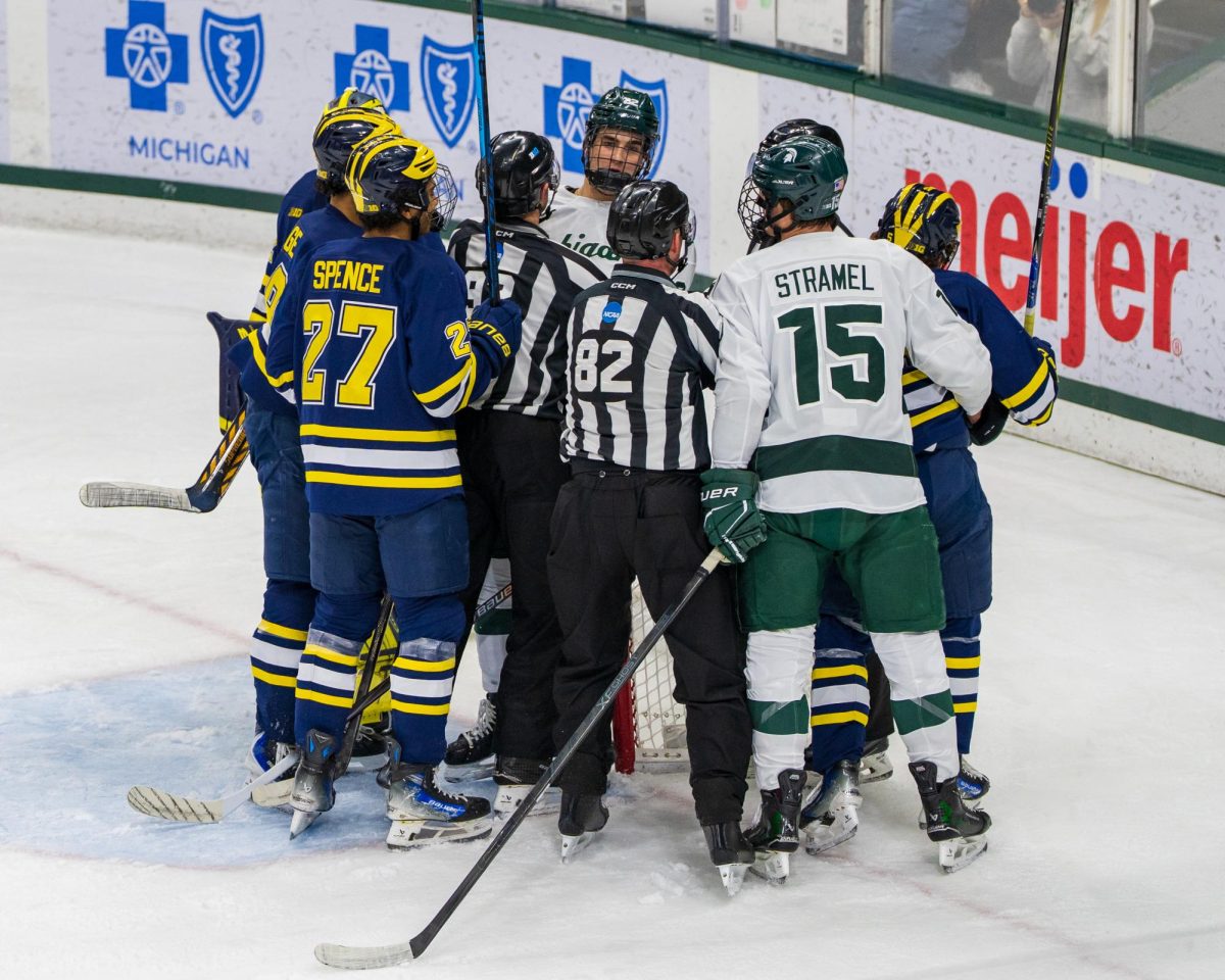 Referees separate Michigan and MSU in the contest at Munn Ice Arena (Dec. 5, 2025).