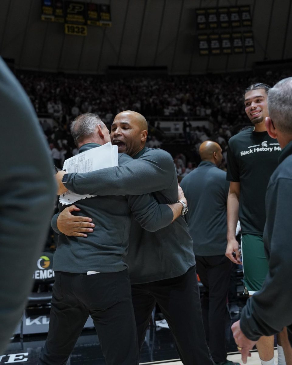 Michigan State's associate head coach Doug Wojcik and assistant head coach Thomas Kelley hug postgame after winning against the Purdue Boilermaker in West Lafayette, Thursday, Feb. 26th, 2026.