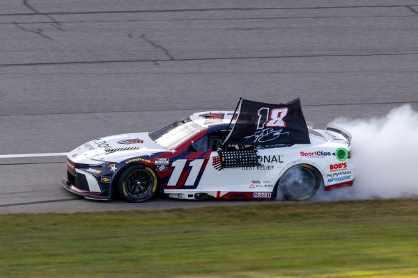 Denny Hamlin takes his victory lap at Michigan International Speedway while honoring the late Kyle Busch. 